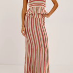 Woman wearing a red and white striped skirt on a plain background