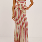 Woman wearing a red and white striped skirt on a plain background