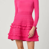 Vibrant pink dress with a sleek, structured silhouette, styled for a festive occasion