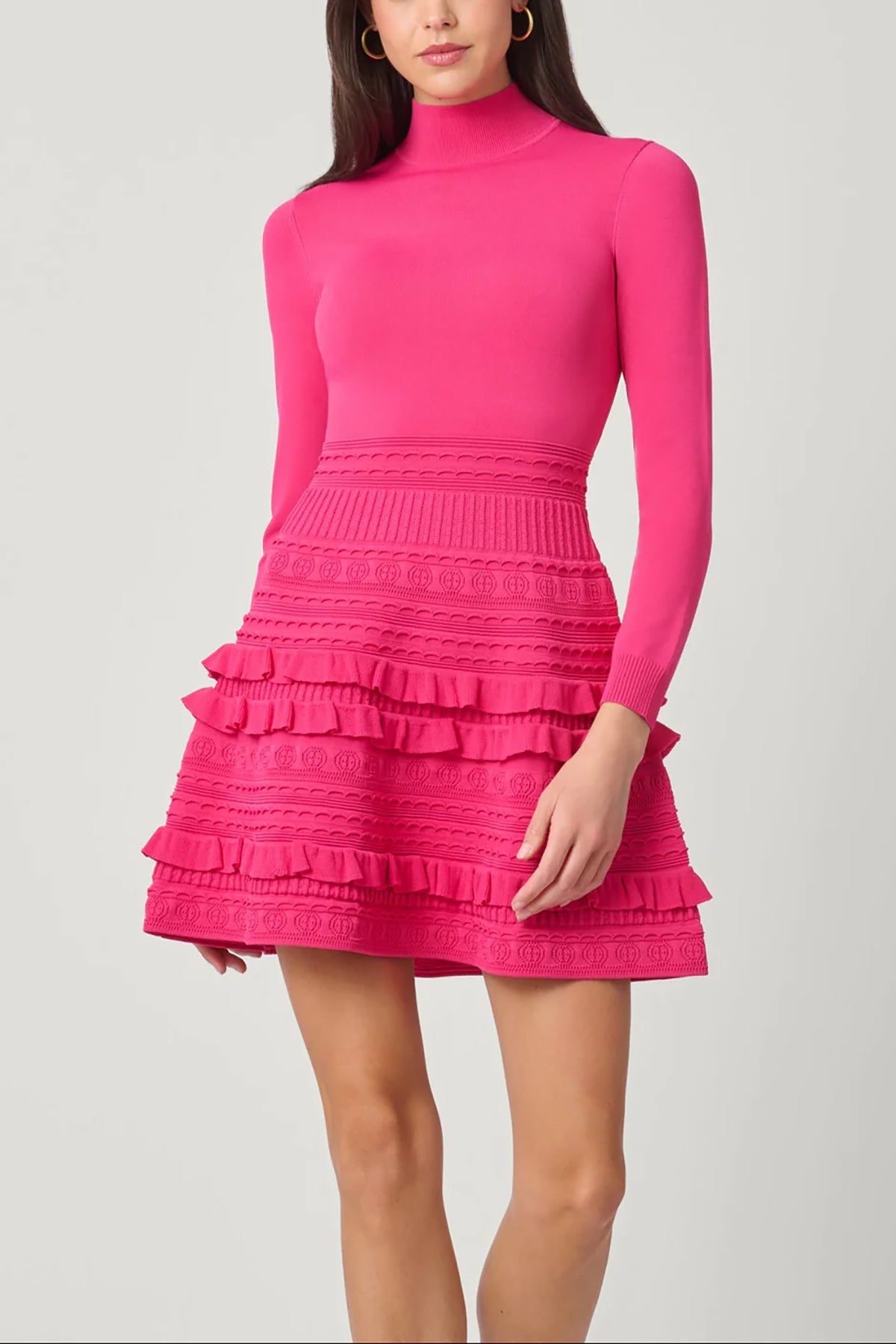 Vibrant pink dress with a sleek, structured silhouette, styled for a festive occasion