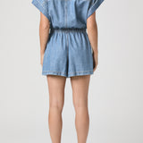 Denim romper worn by a person on a white background