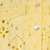 close up of yellow lace cutout jacket on white background 