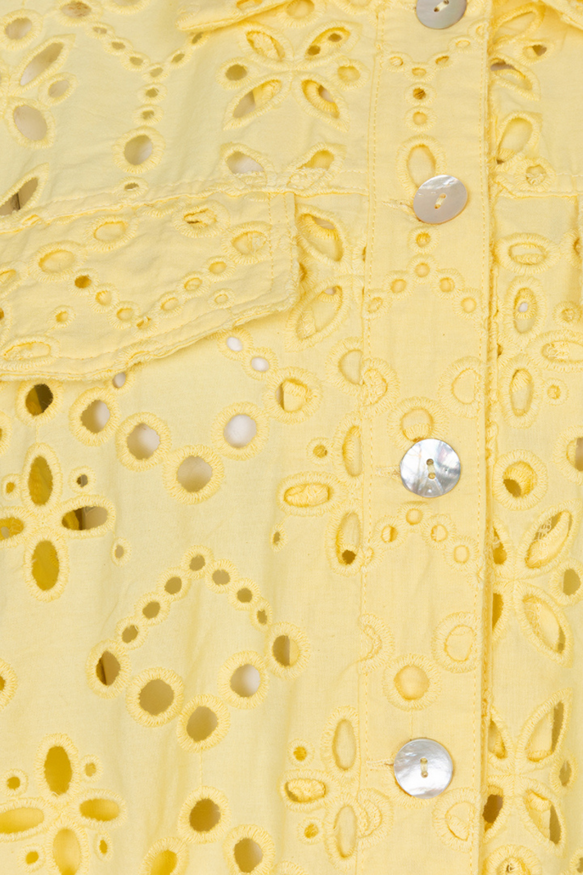 close up of yellow lace cutout jacket on white background 