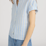 side view of woman in stripe button down short sleeve on white background 
