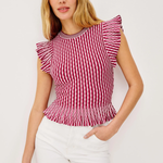 Woman wearing a red and white striped top with ruffled sleeves against a white background