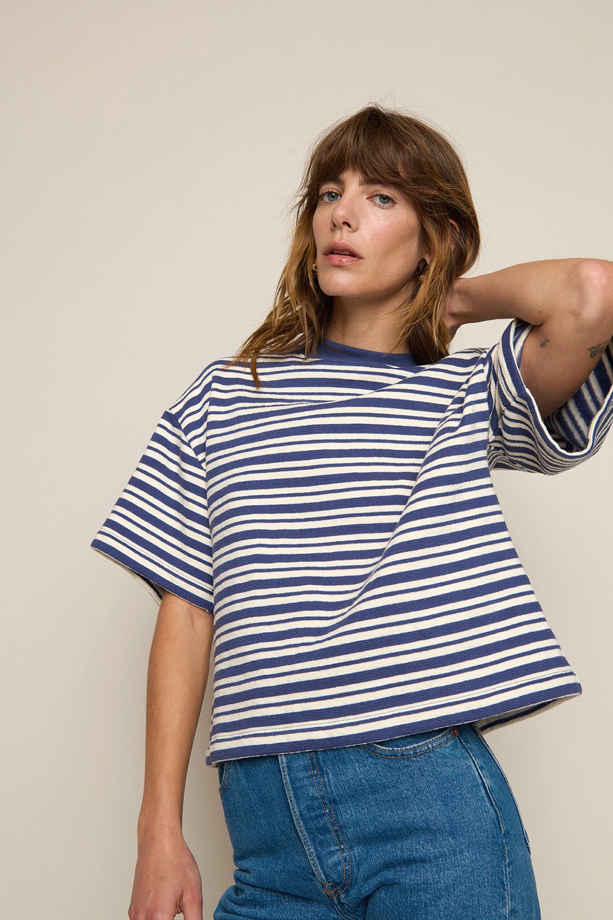 Striped long-sleeve sweatshirt styled with denim