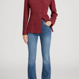 Person wearing a red shirt and blue jeans on a white background