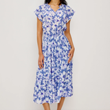Woman wearing a blue floral dress on a white background