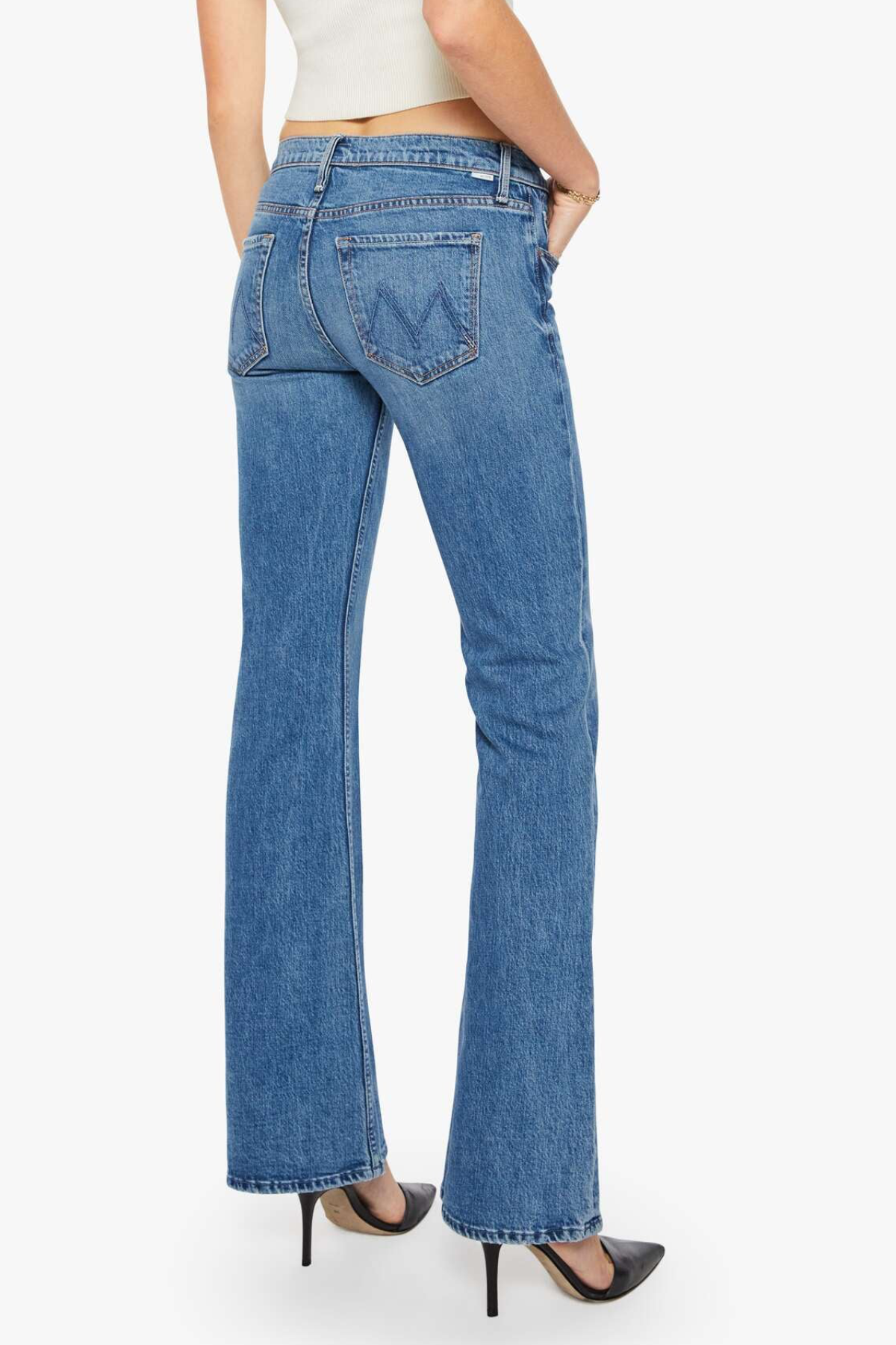 Blue jeans worn by a person on a white background