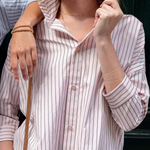 Woman wearing a striped shirt with a blurred background