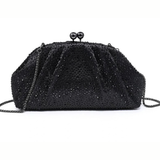 A black beaded evening clutch bag with a chain strap and a kiss-lock clasp adorned with two black beads, shown against a plain white background.