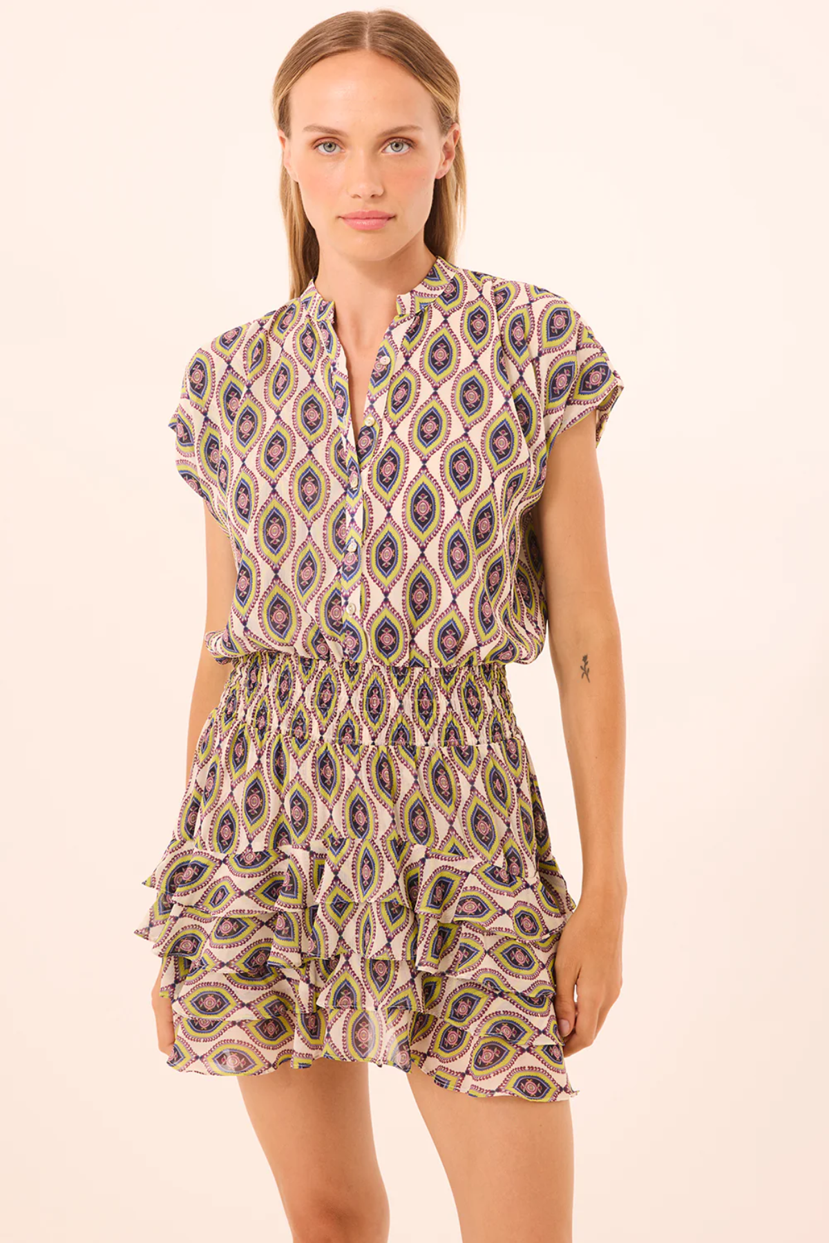 Woman wearing a patterned dress on a beige background