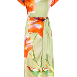 Colorful floral dress with orange, green, and white flowers on a white background