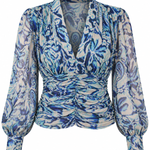 A long-sleeve blouse with a blue and white abstract floral pattern, featuring a gathered ruched waist and a deep V-neckline, shown against a plain white background.