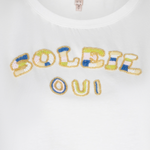 close up of beaded t-shirt on white background 