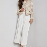 Collarless tailored jacket in a neutral tone, styled over a lightweight top