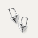 Heart-shaped silver earrings on a light gray background