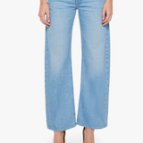 Light blue jeans worn by a person on a white background
