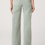 Person wearing light green wide-leg jeans on a plain background