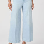 Light blue jeans worn by a person on a white background