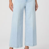 Light blue jeans worn by a person on a white background