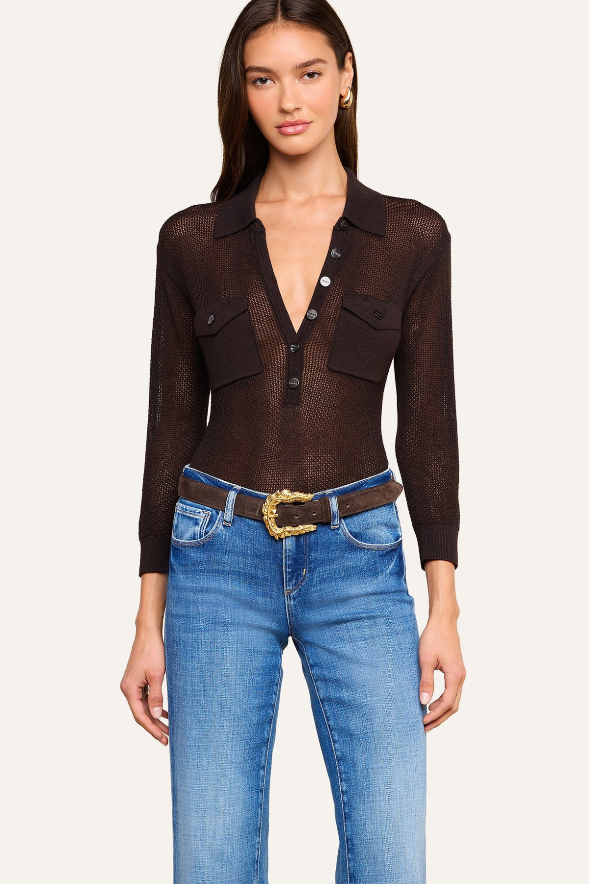 Women's blue pointelle knit sweater featuring a collared neckline and long sleeves.