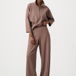 Woman wearing a brown outfit on a white background