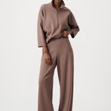 Woman wearing a brown outfit on a white background