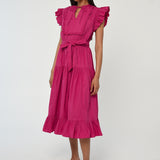 Woman wearing a vibrant pink sleeveless midi dress with soft tailoring and fluid drape.