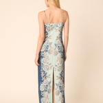 Woman wearing a floral dress with a beige background