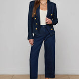 Navy structured blazer styled over a simple top.