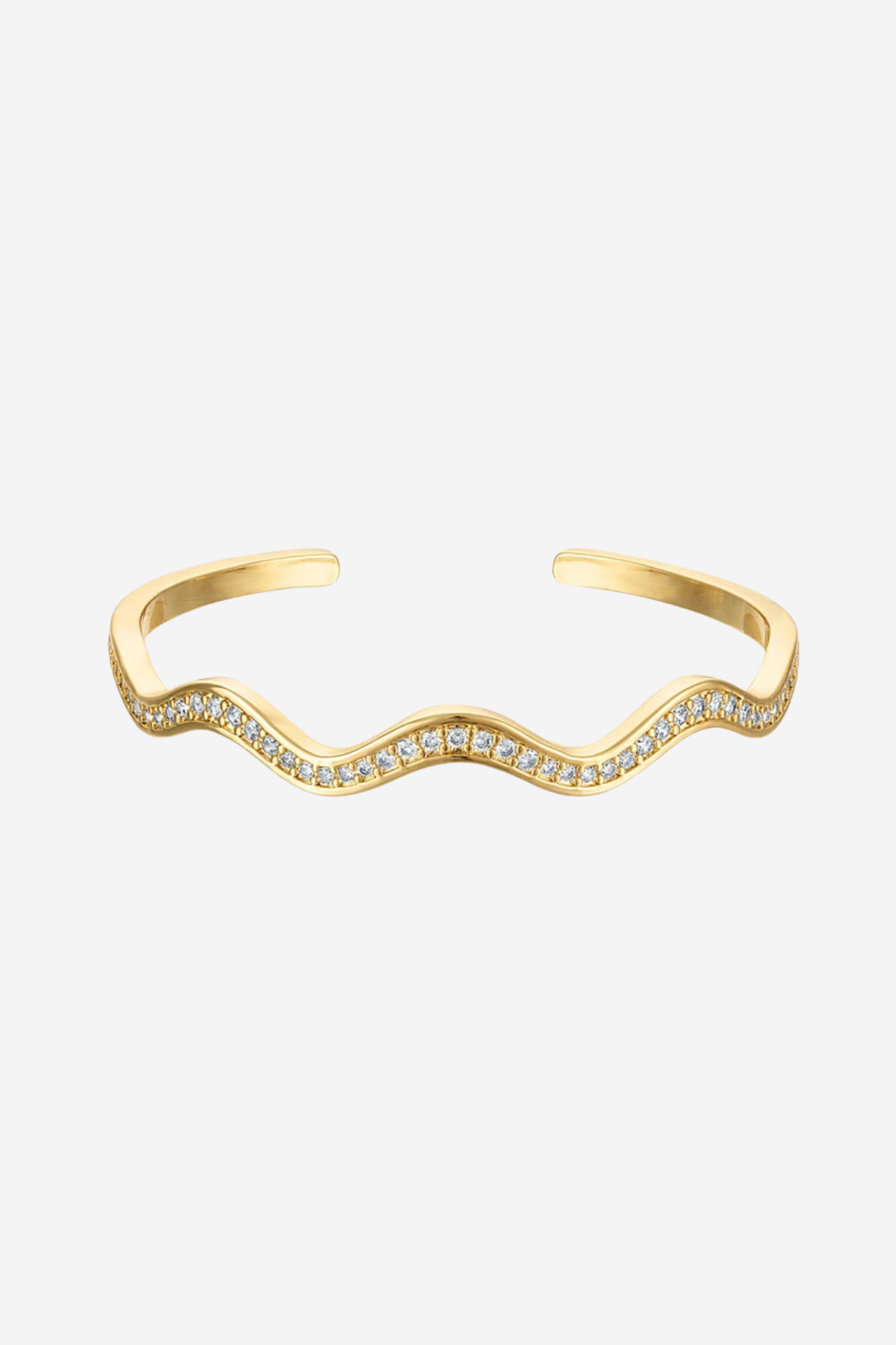 A gold wavy open cuff bracelet adorned with small clear pavé stones along the front curve, shown on a light gray background.
