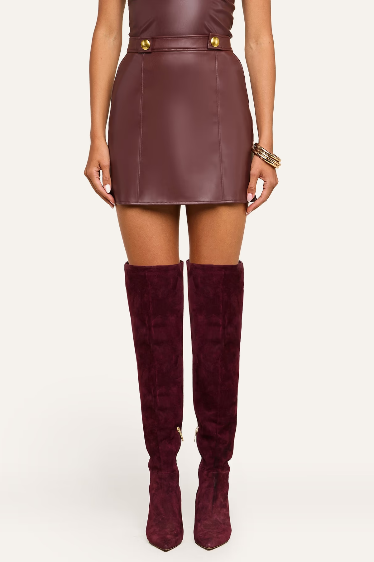 Women's brown mini skirt featuring button-tab detailing and a structured silhouette.