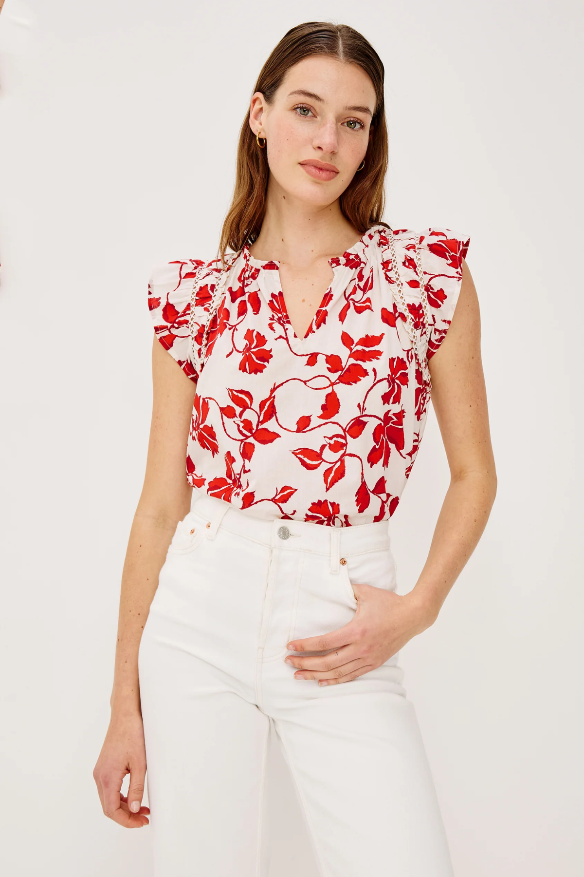 woman in red and white printed top on white background 