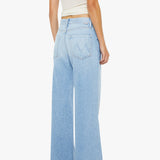 Person wearing light blue wide-leg jeans and a white top on a white background