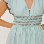 Light blue dress with lace details on a plain background