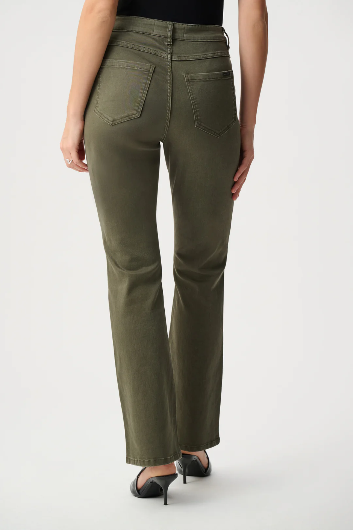 Person wearing olive green pants on a white background
