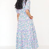 Woman wearing a floral dress on a white background