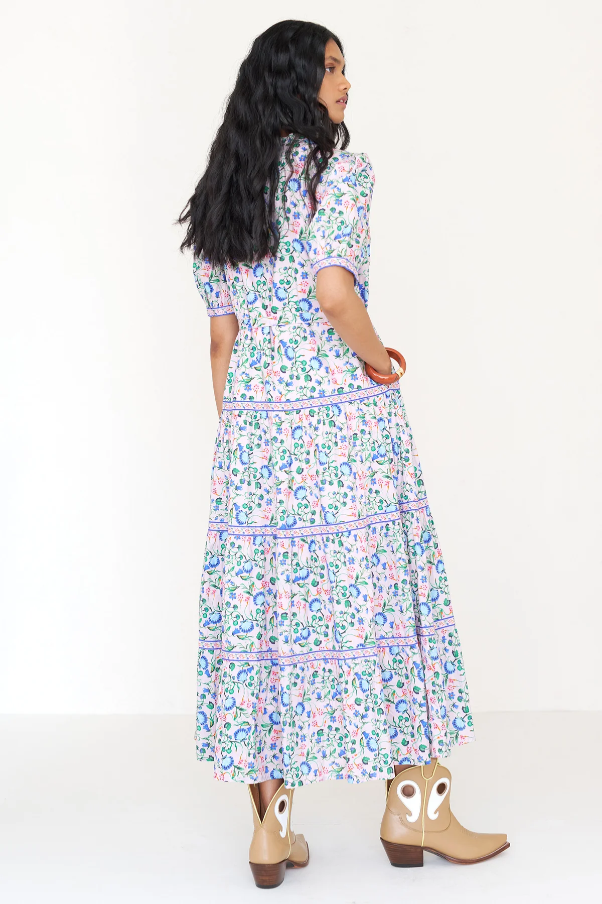 Woman wearing a floral dress on a white background