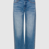 Light blue denim jeans with decorative gold-tone rivet detailing running down the outer seams, shown against a light gray background.