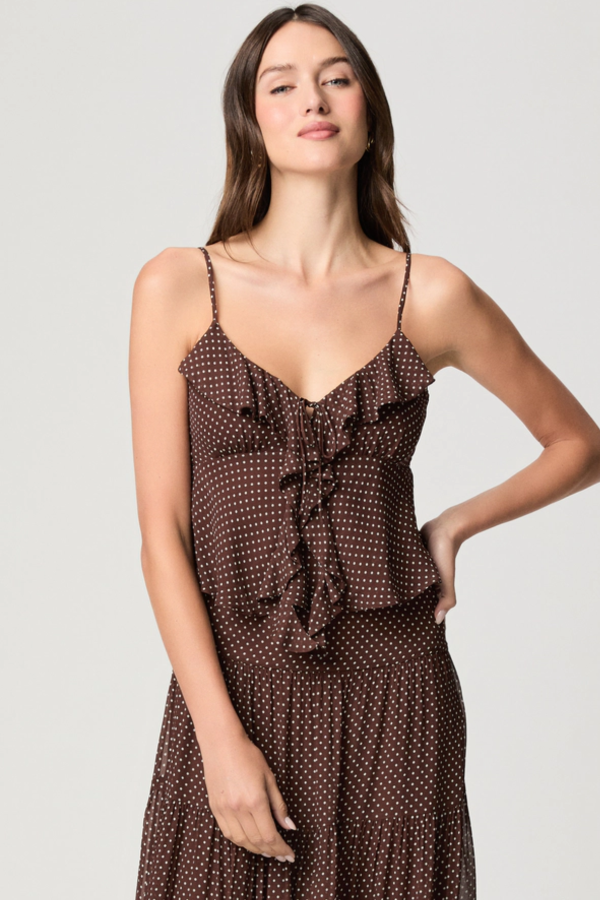 Model wearing a mahogany and ecru color-block camisole with adjustable straps.