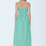 Woman wearing a green striped dress on a white background