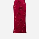 A red midi skirt with a floral jacquard pattern, shown flat against a light gray background.