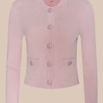 Pink cardigan with button details on a beige background