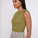 Model wearing an olive green sleeveless knit tank.