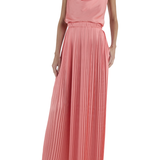 Woman wearing a pink pleated dress on a white background