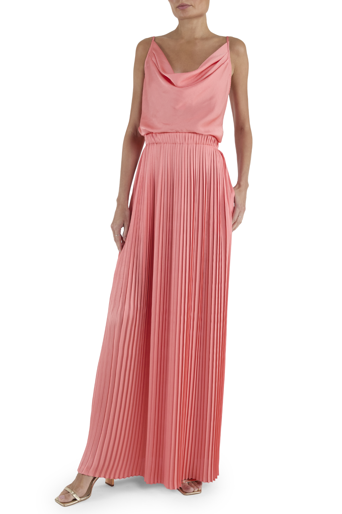 Woman wearing a pink pleated dress on a white background