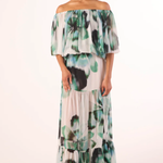 Woman wearing a floral off-shoulder dress on a white background