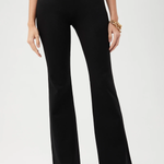 Person wearing black wide-leg pants on a white background