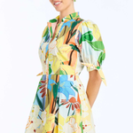 Woman wearing a colorful floral dress on a white background